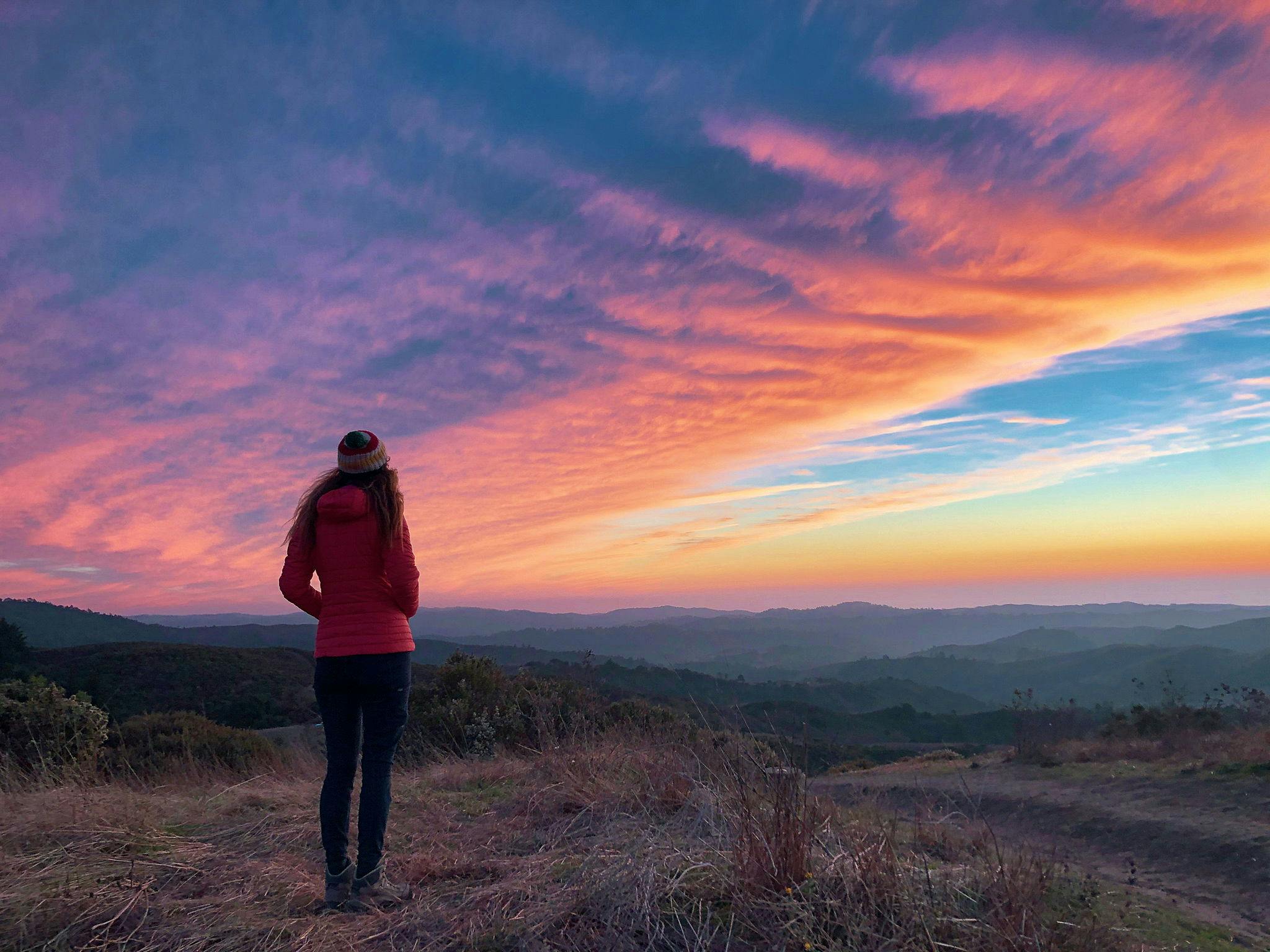 Woman watching a sunset at Windy Hill Preserve in the South Bay 