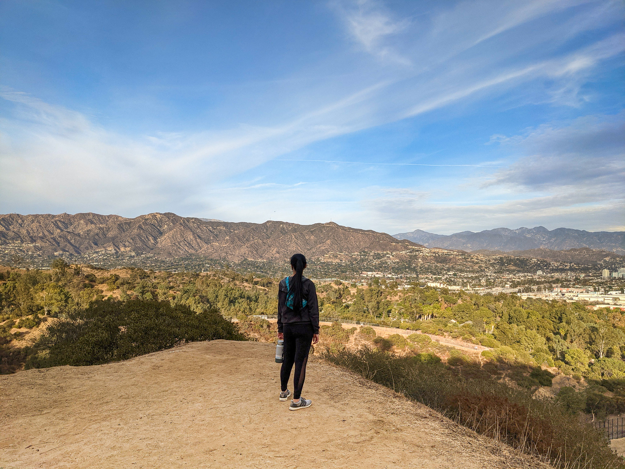 A couple looking at the painted Rock Snake at Lake Elsinore on the Levee Trail