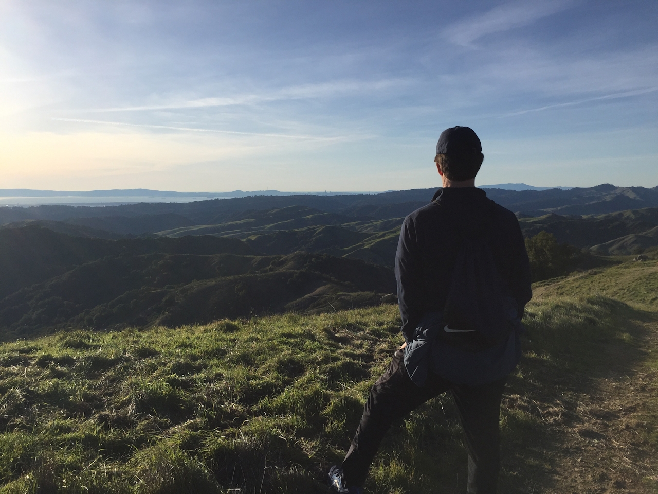 Hiker overlooking the scenery from a trail in Las Trampas Regional Wilderness