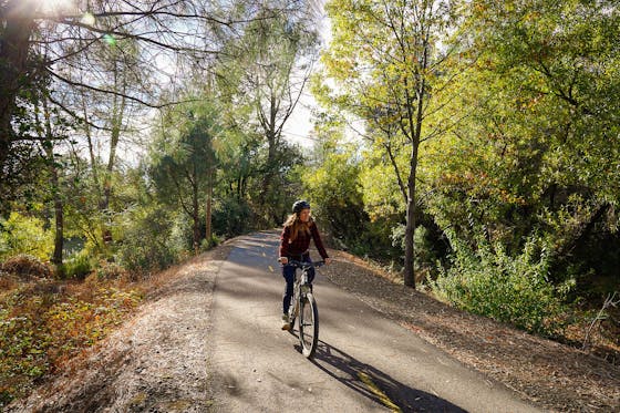 Woman biking on the El Dorado Trail in Placerville 