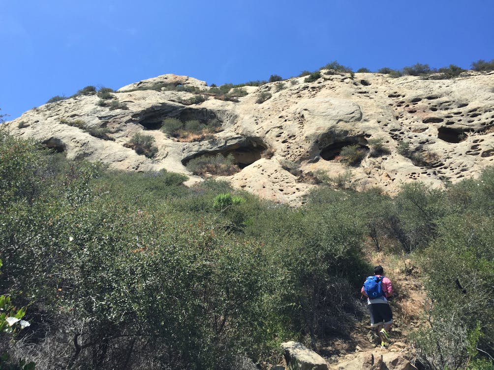 Hiker on a trail to Gaviota Wind Caves 