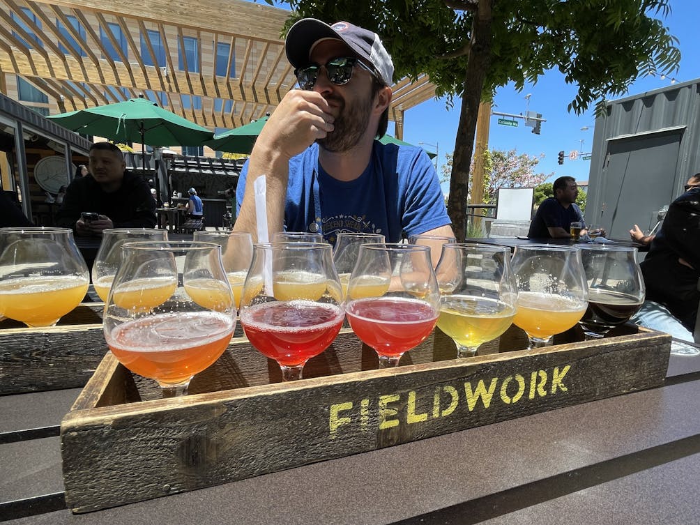 Person overlooking the beer tasting options at Fieldwork Brewing 