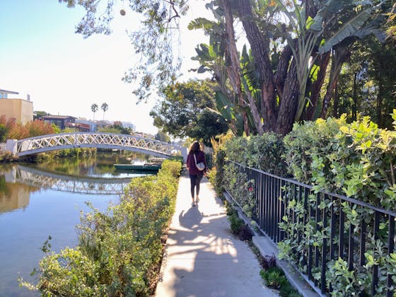 Woman walking in the Venice Canals of Los Angeles County 