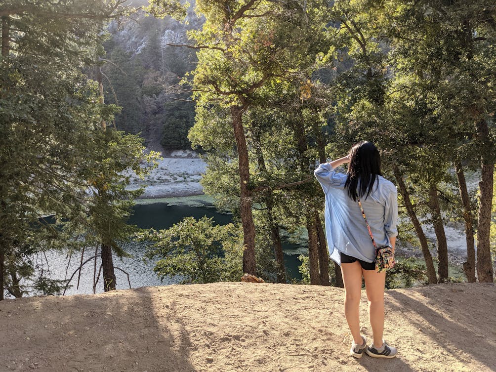 Woman staring out at Crystal Lake in Crystal Lake Recreation Area in Angeles National Forest Southern California 