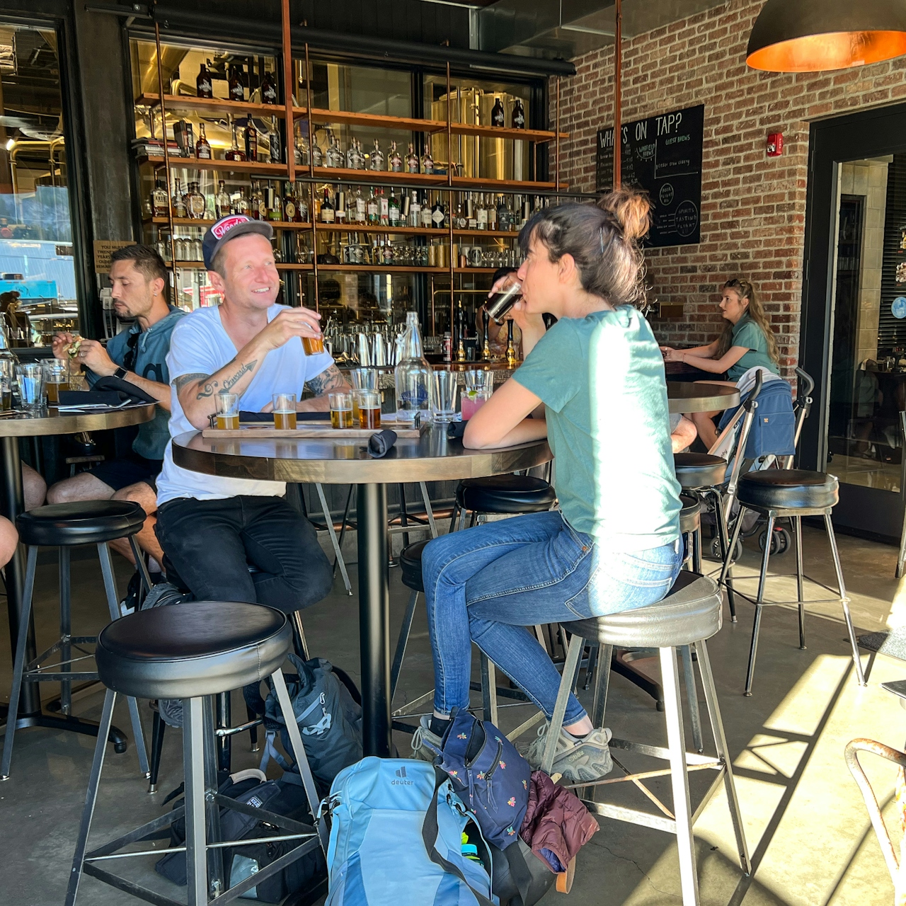 Two people enjoying beer and food at Warfield Distillery in Ketchum Idaho 