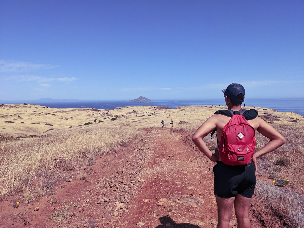 Hiker taking in the ocean and coastal scenery at Santa Cruz Island on Channel Islands National Park 