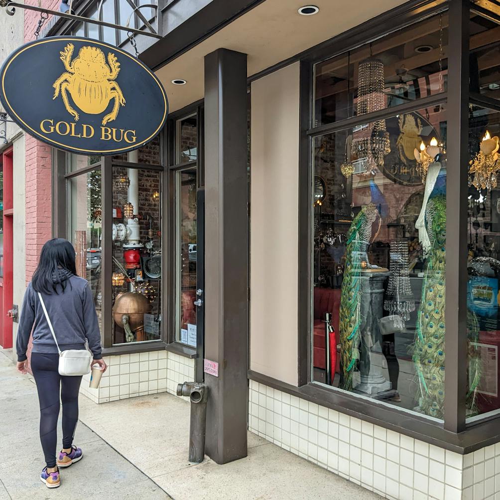 Woman walking by the eclectic Gold Bug store in Pasadena 