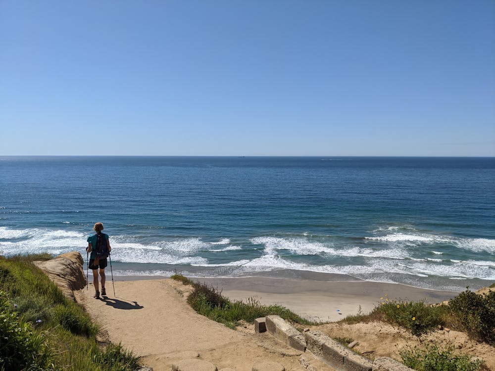 Woman hiking down towards Blacks Beach in La Jolla 