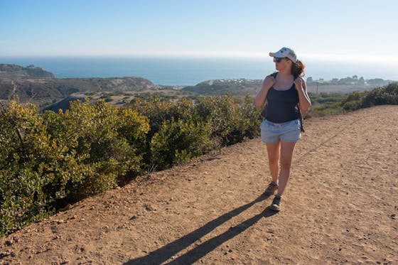 Woman hiking the backcountry trails overlooking the Pacific at Crystal Cove State Park 