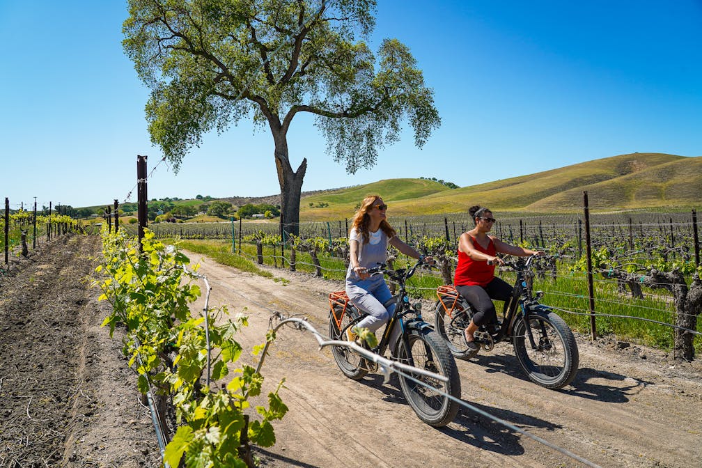Two women on e-bikes at Cass Vineyard and Winery near Paso Robles 
