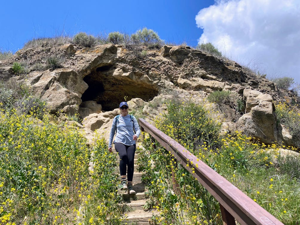 A woman walks down the stairs from a cave in the Wildwood Canyon part of Thousand Oaks in Ventura County 