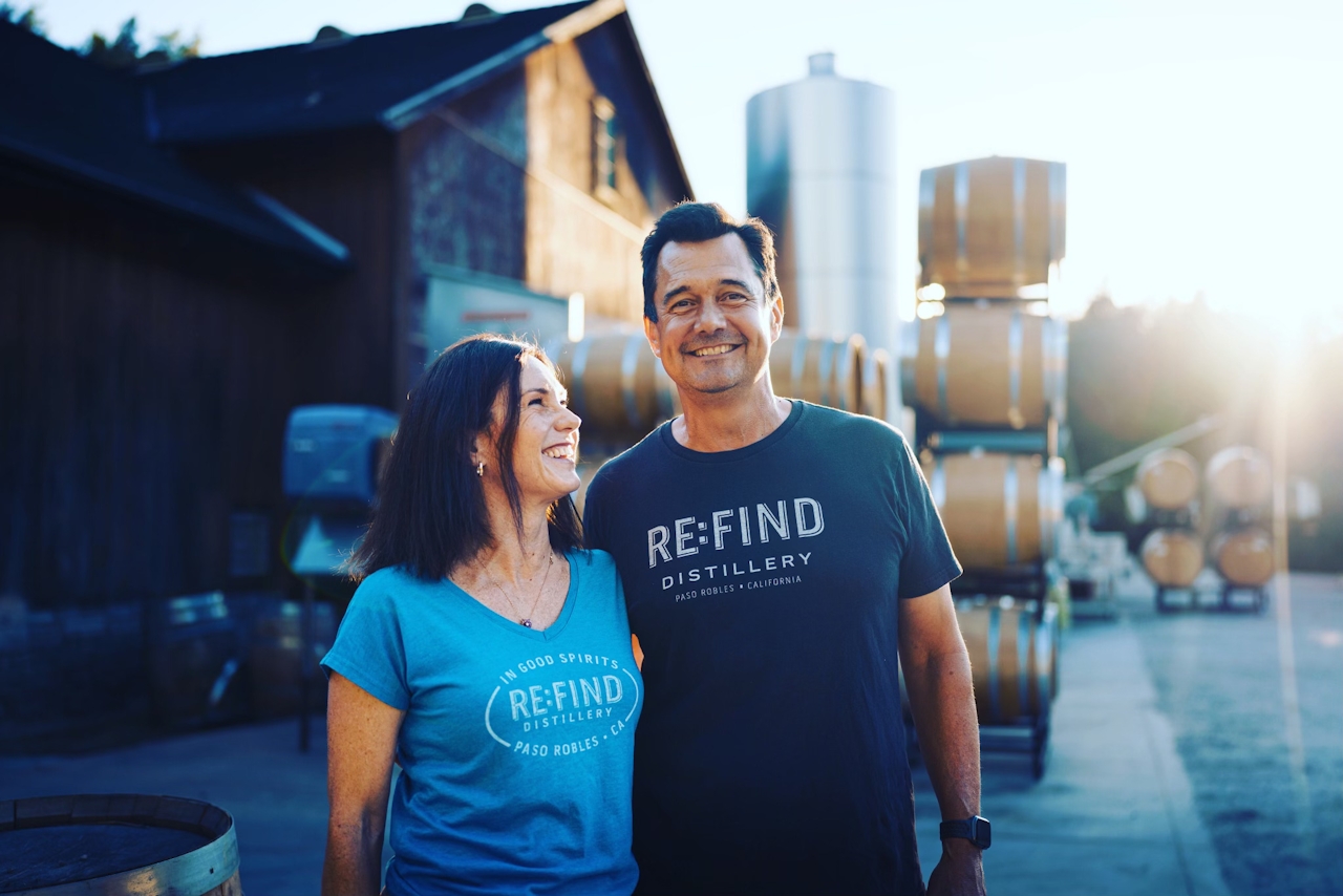 Alex and Monica Villicana, wearing Re:Find Distillerytee shirts and standing out in front of Villicana Winery and Re:Find Distillery