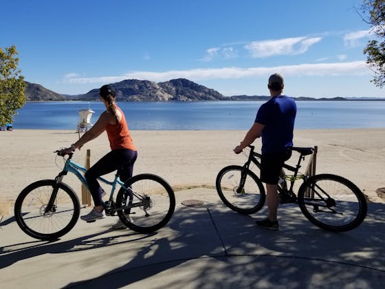 Two bike riders are looking out to Lake Perris in Southern California 