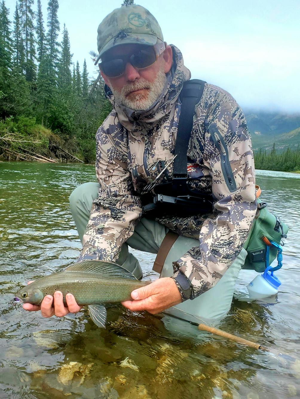 Jim Litchfield holding a fish from a fly fishing adventure 