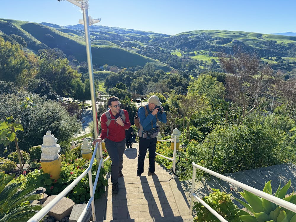 A man takes a break at a temple spot on a hike at Dragon Mountain in Milptas