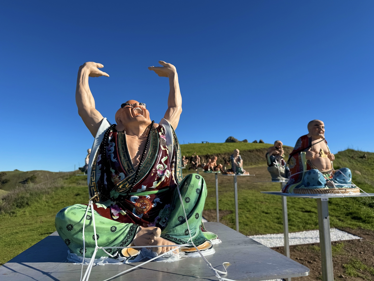 Happy buddha statues are on display at the top of the hill at Dragon Mountain in Milpitas 