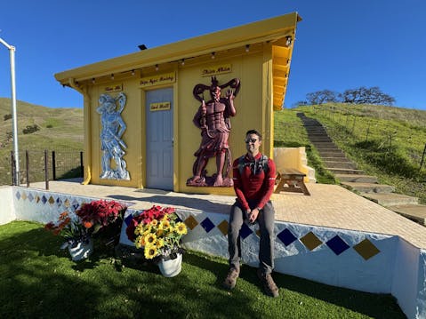 A man takes a break at a temple spot on a hike at Dragon Mountain in Milptas