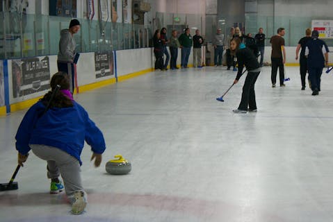 People on ice learning to curl at Hollywood Curling