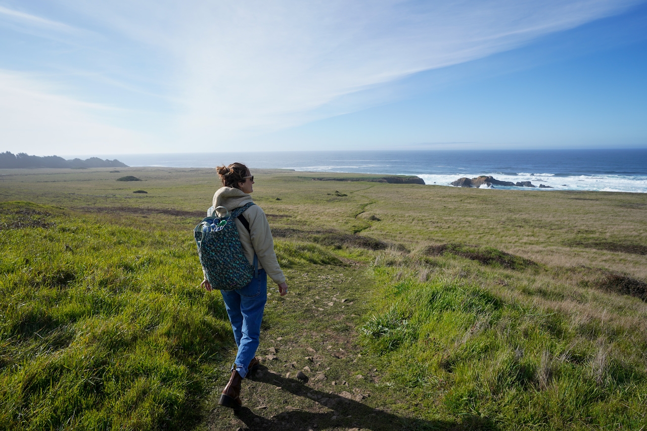 A woman stands looking out to the sea at sprawling Spring Ranch in Mendocino 