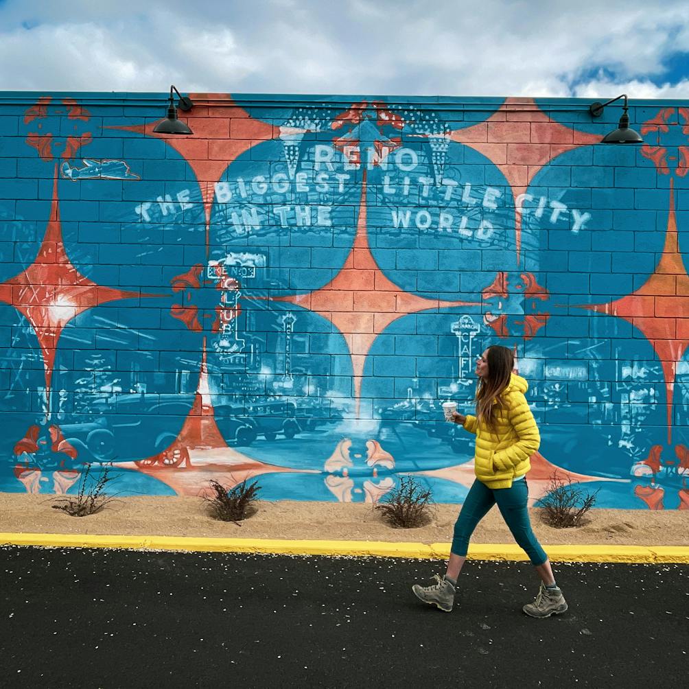 Woman walking by Kramer's Midtown mural in Reno 