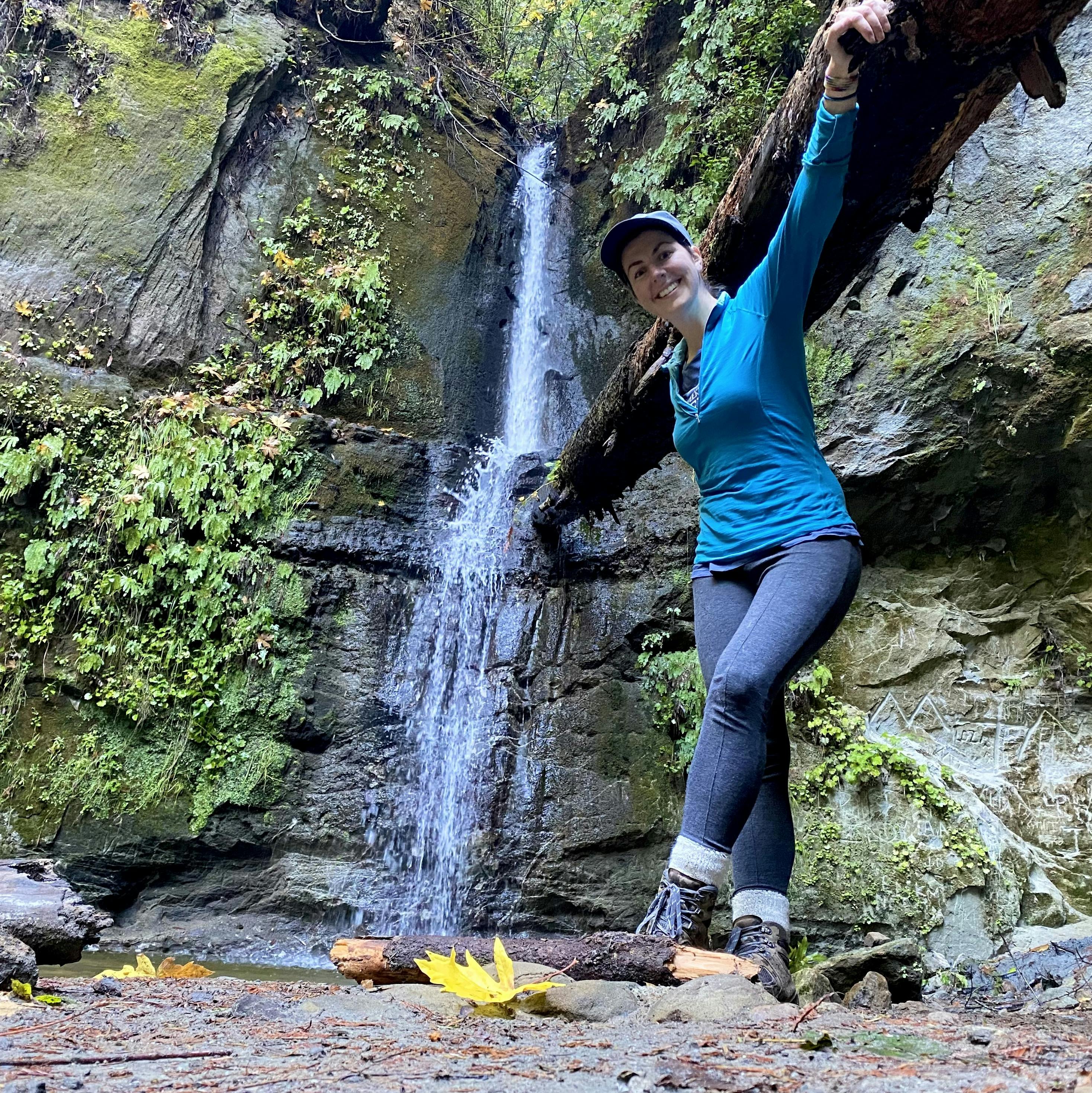 Hiker posing in front of Maple Falls at The Forest of Nisense Marks State Park