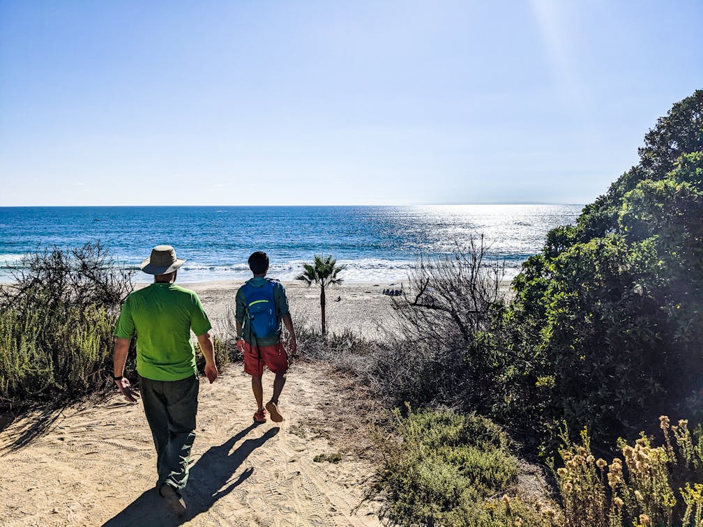 Two people walking towards Salt Creek Beach in Dana Point Orange County 