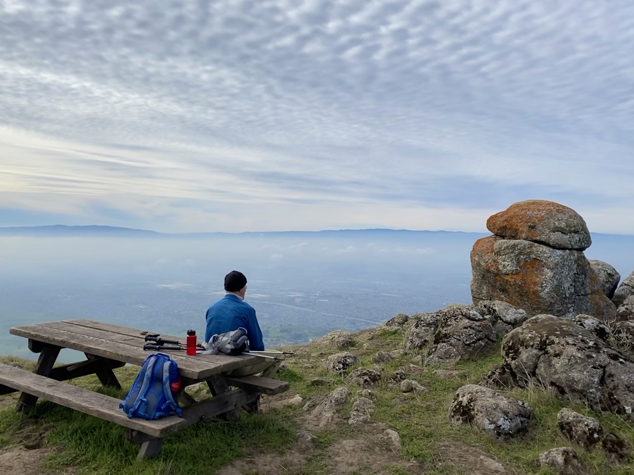 Man at a picnic table overlooking the East Bay at Ed R Levin County Park 