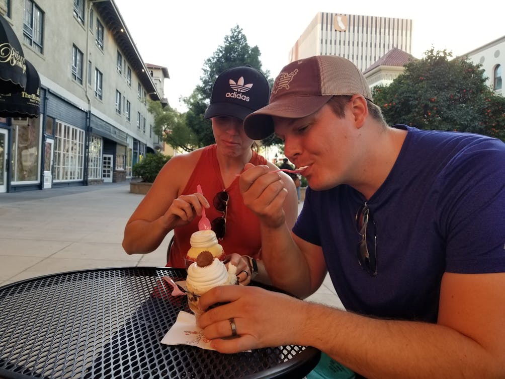 Two people enjoying Casey's Cupcakes at an outdoor patio in Riverside