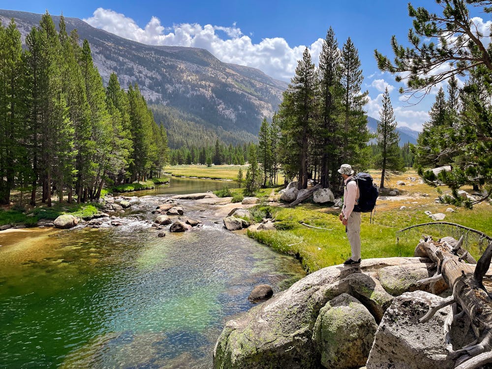 Backpacker on Tuolumne River in Yosemite High Sierra