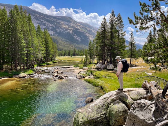 Backpacker on Tuolumne River in Yosemite High Sierra