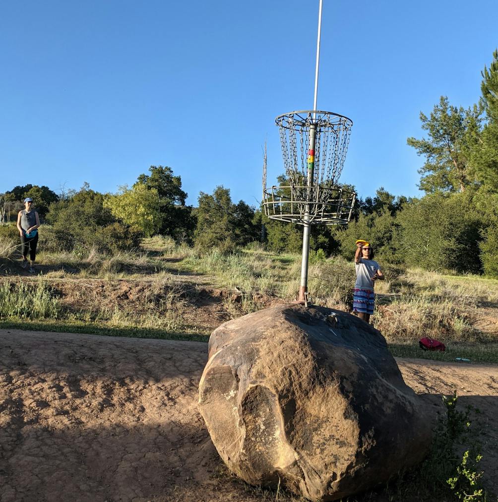 Person tossing a disc at Coyote Point Disc Golf Course at Lake Casitas Recreation Area near Ventura 