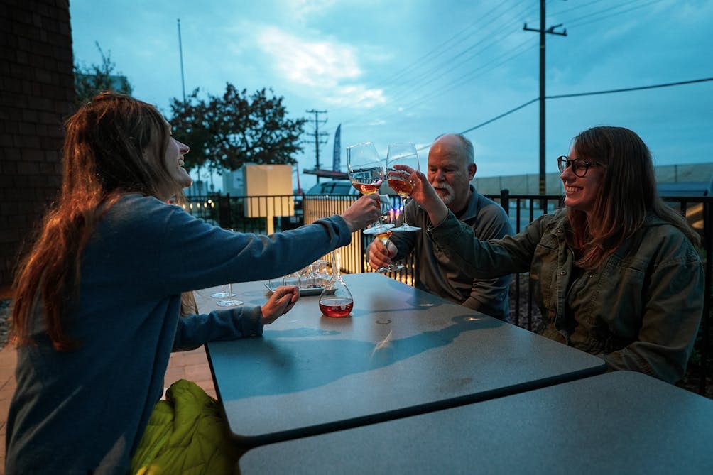 Mike Brown of Cantara Cellars and Flat Fish Brew Co. toasting guests with barrel-aged brandy samples on the outdoor patio of Camarillo Barrel Works