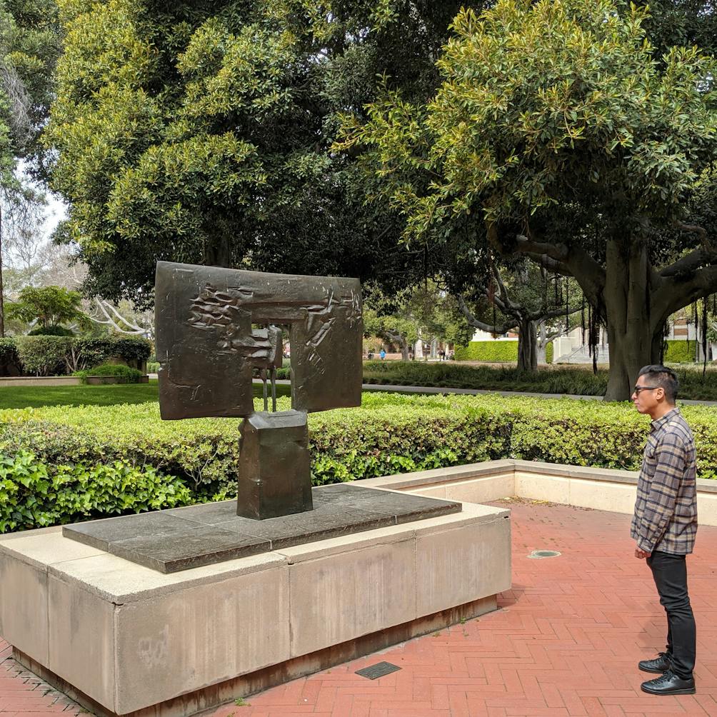 Person looking at outdoor sculpture on UCLA campus 