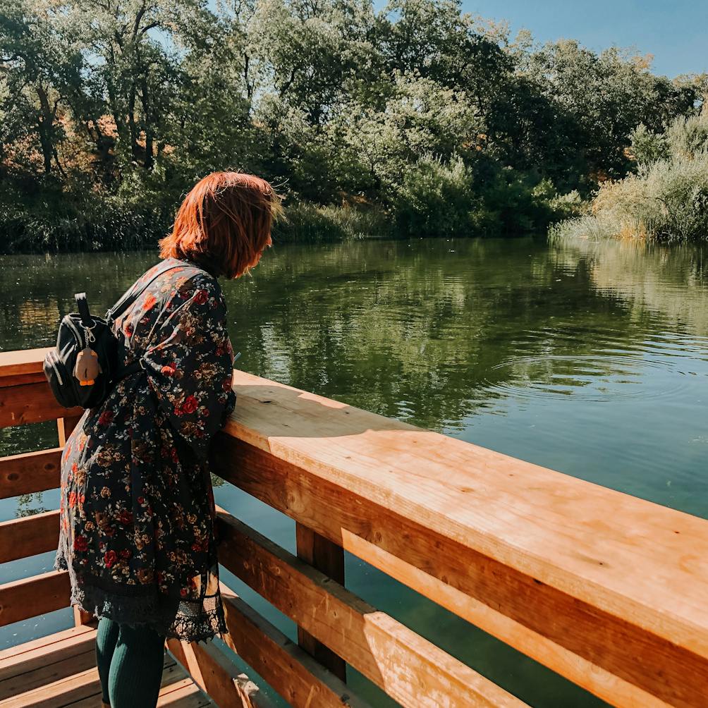 Hiker at a deck overlooking a wetland at Oak Glen Preserve in the Inland Empire Southern California