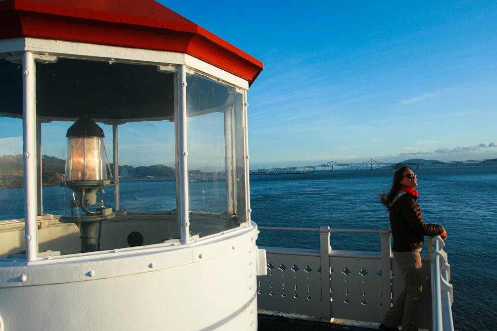 Young woman on the light deck looking out at the sea from East Brother Light Station in the San Francisco Bay Area