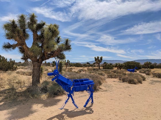 Blue art installation of deer near a Joshua Tree in the Antelope Valley