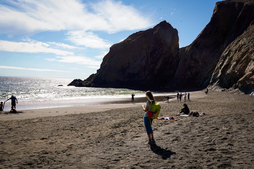 Woman on Tennessee Cove beach in the Marin Headlands 