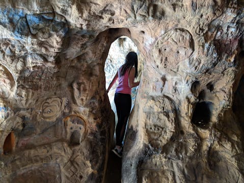Hiker going through Vanalden Cave in the Santa Monica Mountains