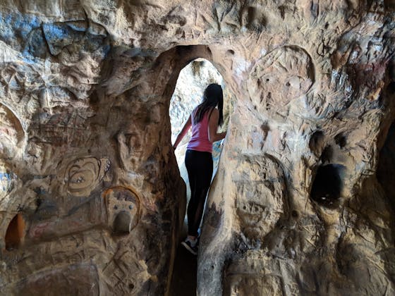 Hiker going through Vanalden Cave in the Santa Monica Mountains