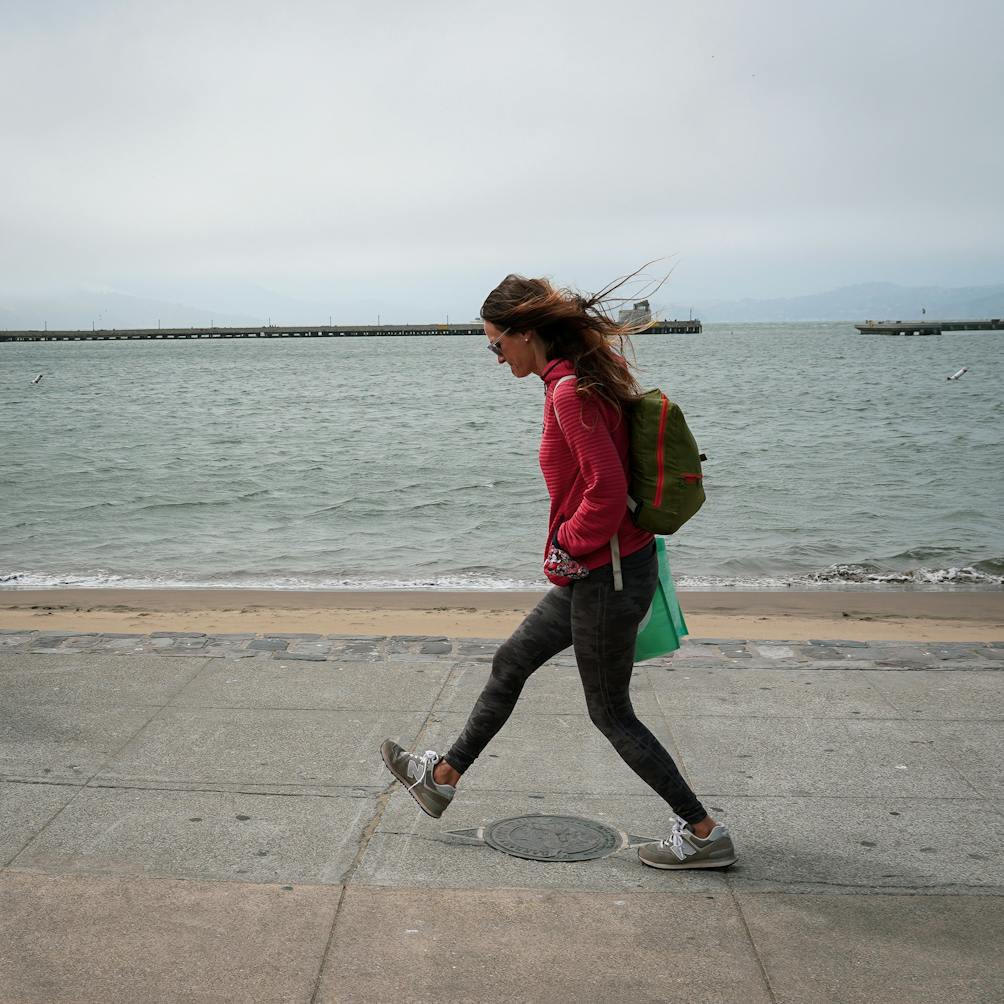 woman walking the Barbary Coast Trail medallion San Francisco