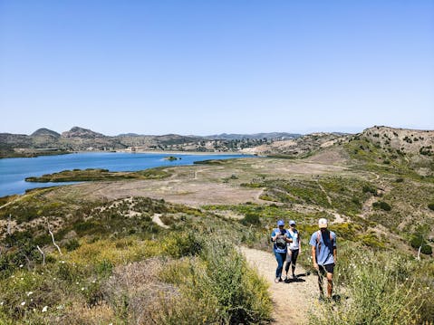 Hikers by the reservoir at Triunfo Creek Park near Thousand Oaks
