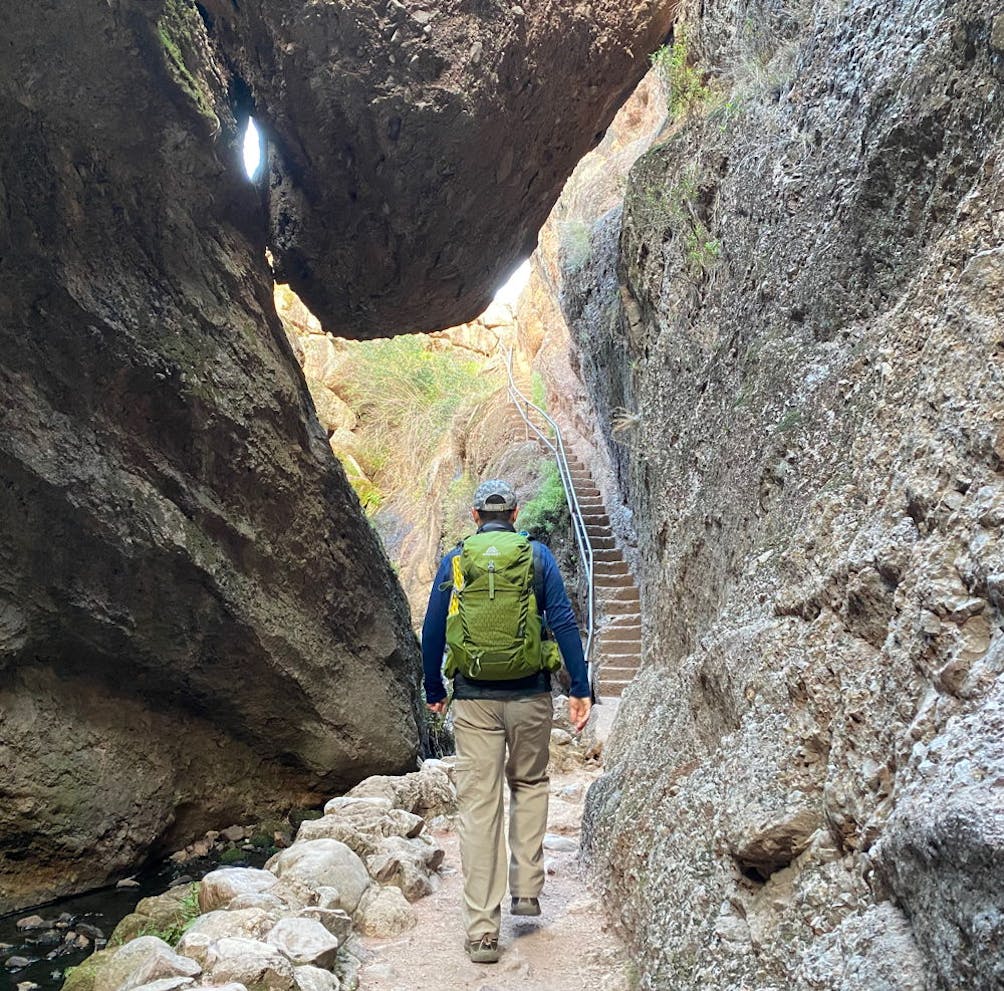 Hiker at Bear Gulch Cave and High Peaks Trail at Pinnacles National Park