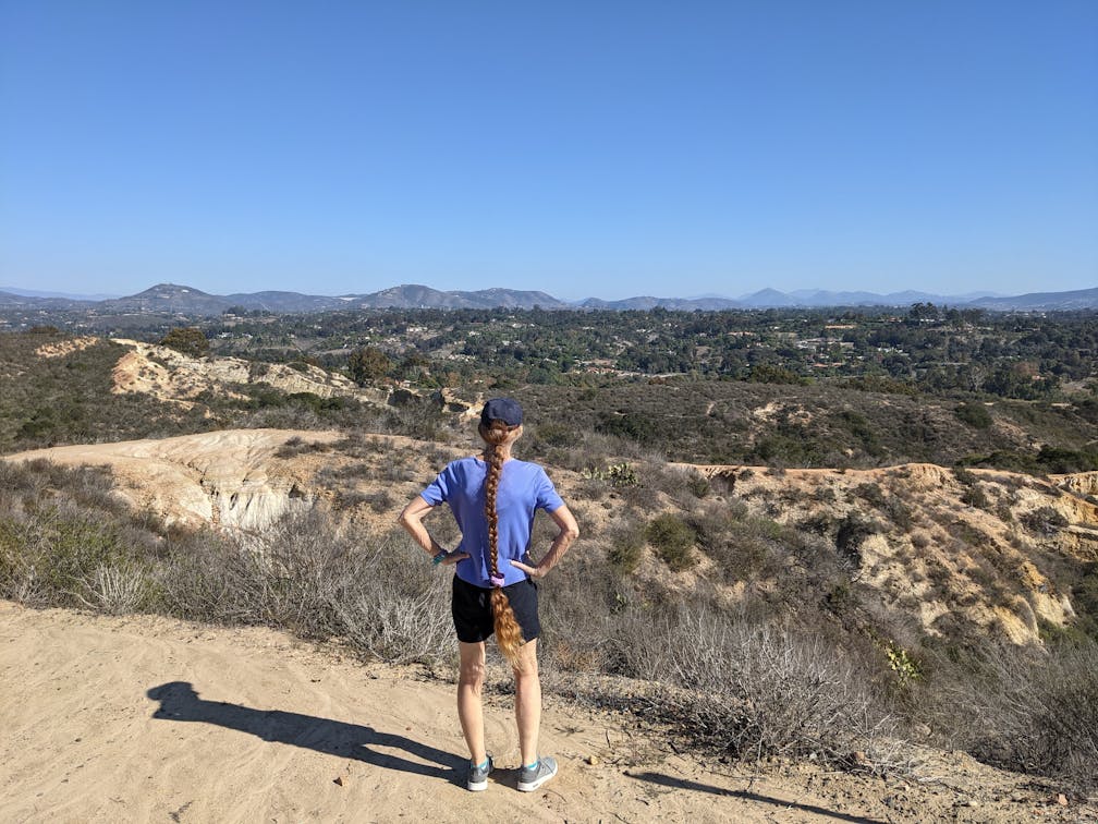 Hiker staring out at mountainous views in Manchester Preserve North San Diego County