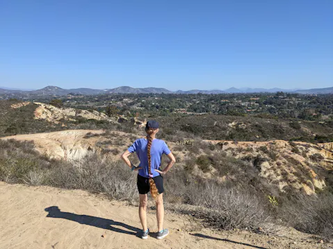 Hiker staring out at mountainous views in Manchester Preserve North San Diego County