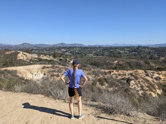 Hiker staring out at mountainous views in Manchester Preserve North San Diego County