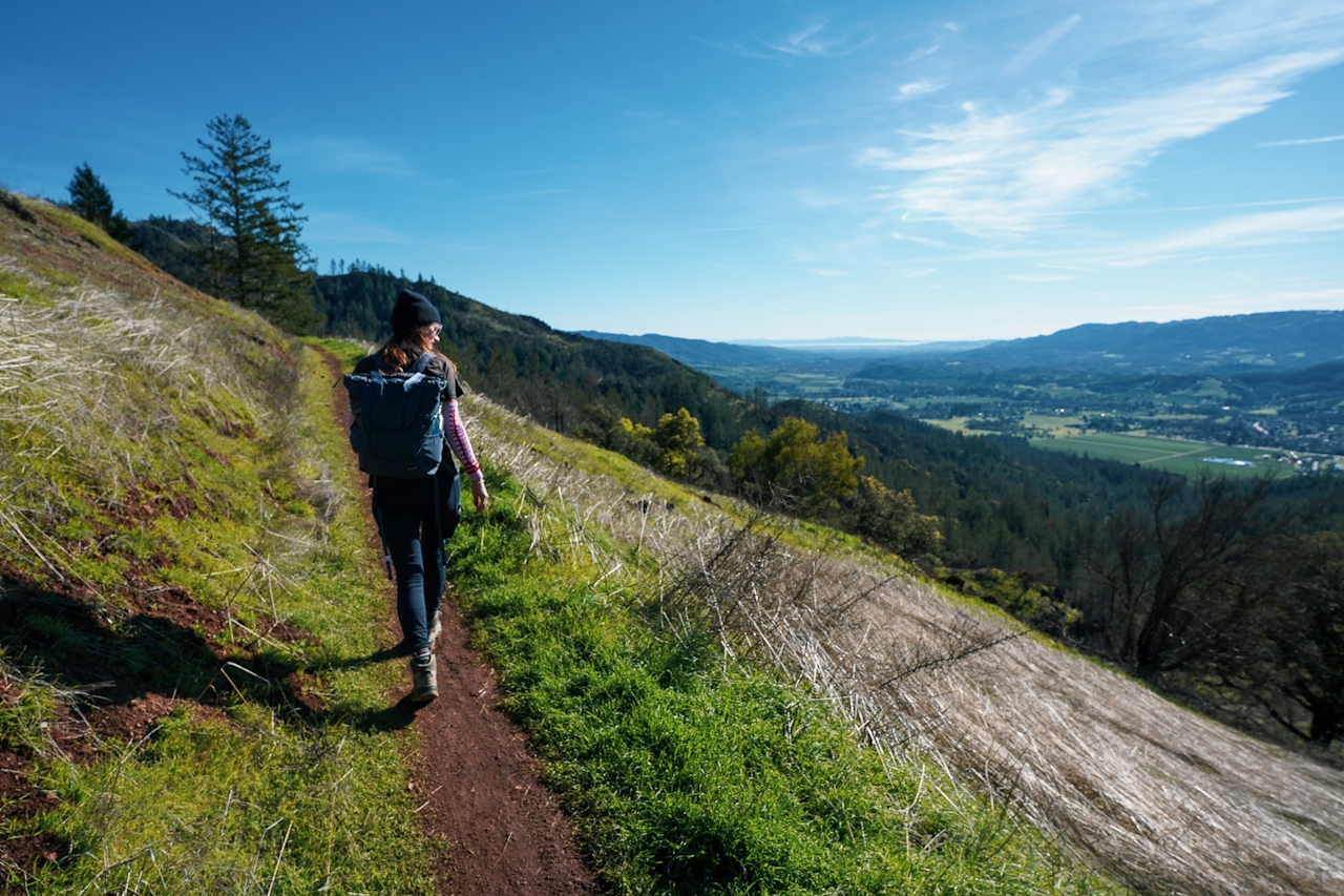 Woman hiking a ridge section of the Lawson Trail in Sonoma Valley Hood Mountain Regional Park and Open Space Preserve