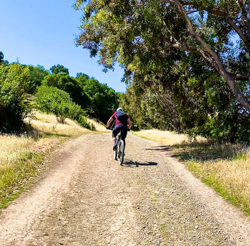 Mountain biker on a wide open trail at Santa Teresa County Park in San Jose 