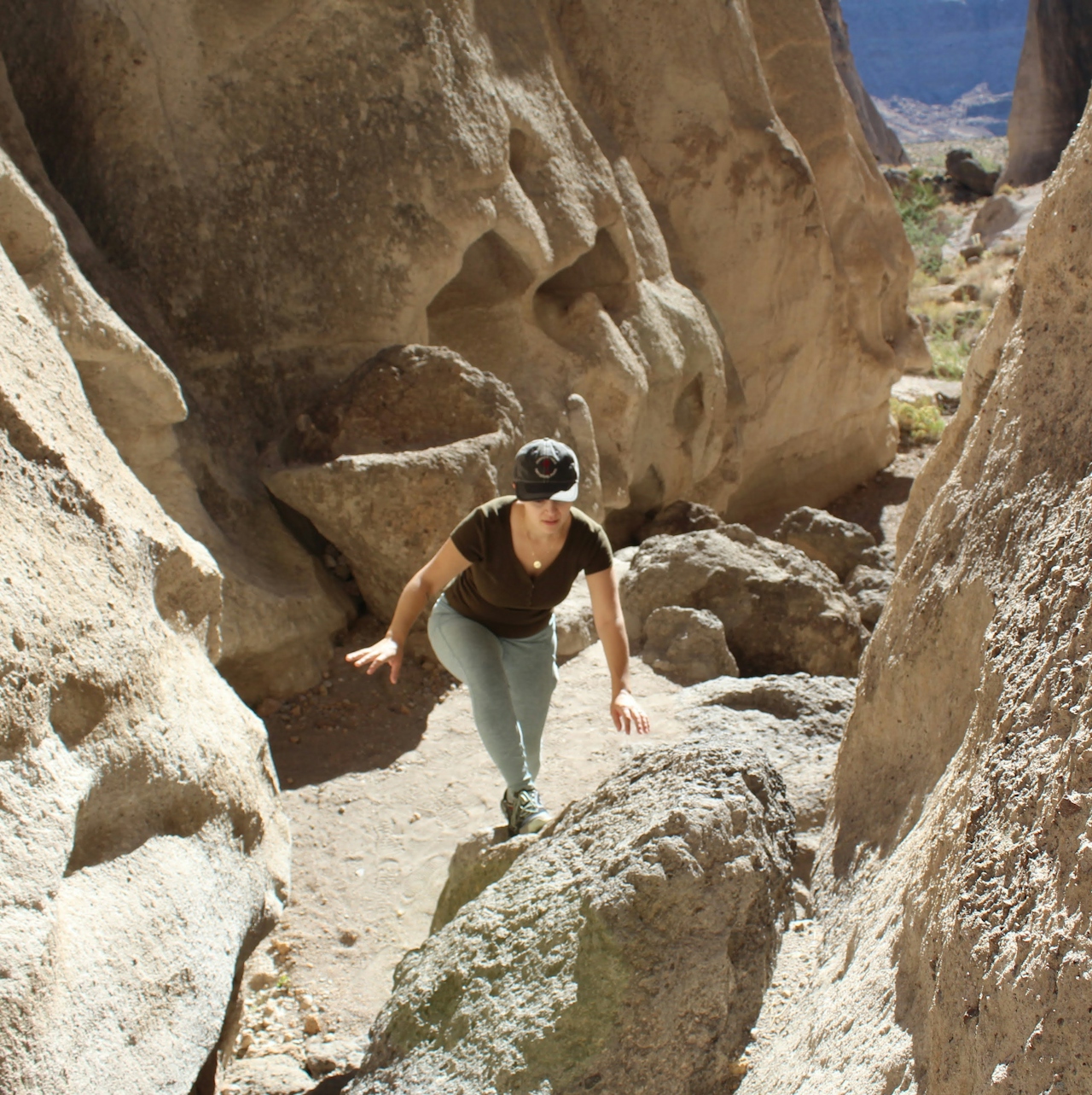 Hiker going up between canyon walls at hole in the wall canyon Mojave desert 