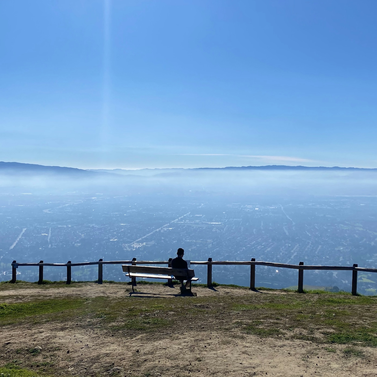 Person at bench overlooking San Jose at Alum Rock 