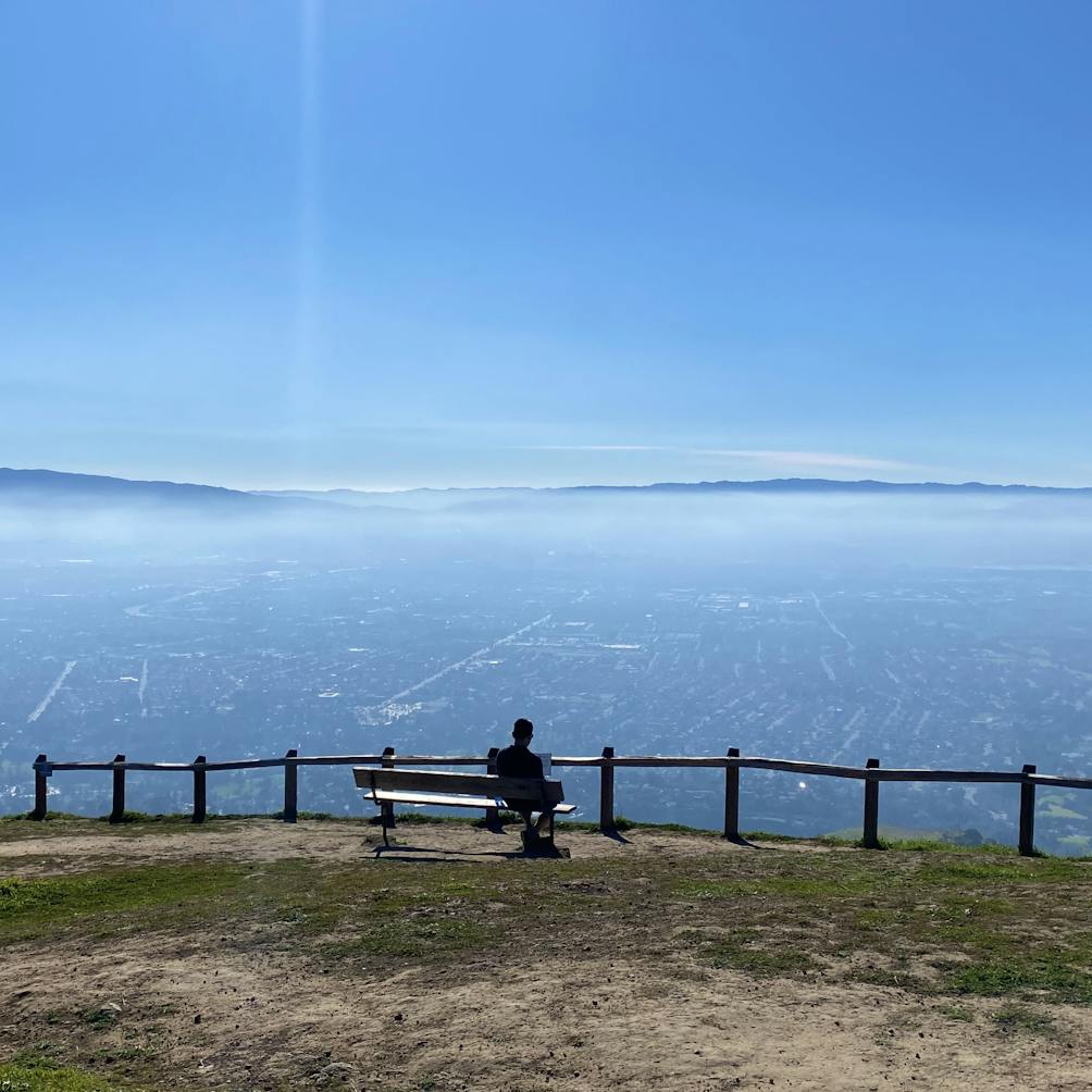 Person at bench overlooking San Jose at Alum Rock 